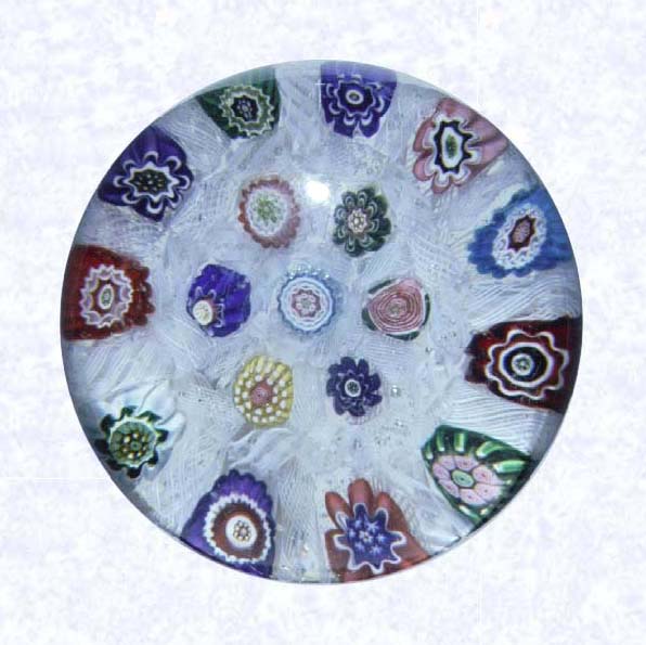 <B>Chequer Millefiori<BR>France<BR>Clichy, circa 1845-55</B><BR>Diameter: 6.5 cm (2 1/2 inches)<BR>(702275)<BR><BR>Chequer millefiori with spaced millefiori canes, including one pink Clichy rose; canes separated by short lengths of white filigree twists; backed by parallel lengths of white filigree twists