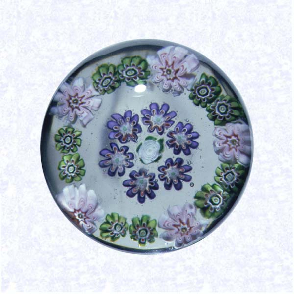 <B>Miniature Pattern Millefiori<BR>France<BR>Clichy, circa 1845-55</B><BR>Diameter: 4.5 cm (1 3/4 inches)<BR>(7023770)<BR><BR>Miniature pattern millefiori weight with concentric rings of millefiori canes in pale pink, green, and purple, around a central white Clichy rose