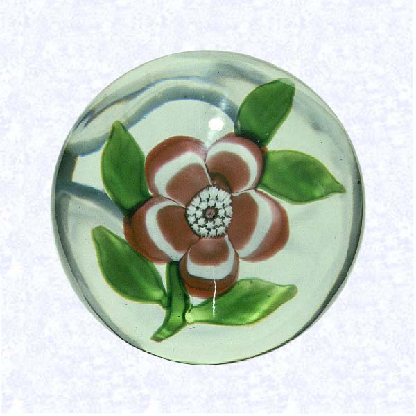 <B>Miniature Pink Lampworked Primrose<BR>France<BR>Baccarat, circa 1845-55</B><BR>Diameter: 4.2 cm (1 5/8 inches)<BR>(702391)<BR><BR>Miniature weight with a deep pink and white banded lampworked primrose blossom with a white center cane; five green leaves and stem