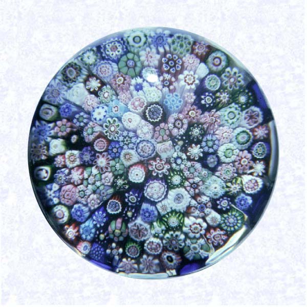 <B>Clichy Close Millefiori<BR>France<BR>Clichy (signed), circa 1845-55</B><BR>Diameter: 6.5 cm (2 1/2 inches)<BR>(702415)<BR><BR>Close millefiori, including one pink and two white Clichy roses and one light blue signature cane inscribed with a red &quotC;" blue and white stave basket