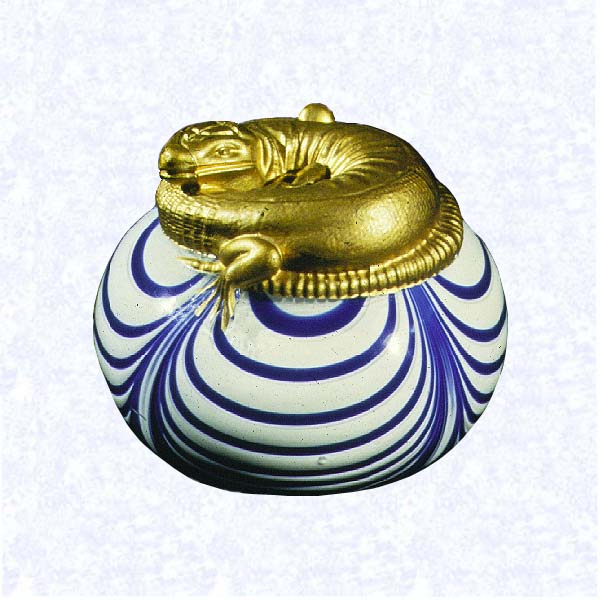 <B>Gilded Salamander<BR>France<BR>Saint Louis, circa 1845-55</B><BR>Diameter: 8.4 cm (3 5/16 inches)<BR>(702426)<BR><BR>Cast-molded, gilded salamander; coiled atop a hollow blown, opaque white weight with blue marbrie festooning