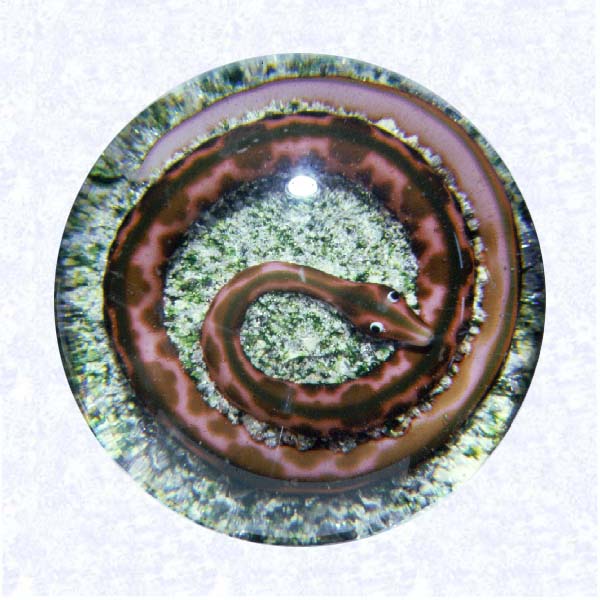 <B>Lampworked Snake on Rock Ground<BR>France<BR>Baccarat, circa 1845-55</B><BR>Rose pink lampworked snake with reddish brown mottling; white eyes with black pupils; coiled on a green and tan rock ground