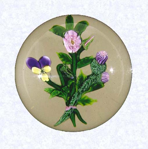 <B>Lampworked Pansy and Clichy Rose Bouquet<BR>France<BR>Clichy, circa 1845-55</B><BR>Diameter: 8 cm (3 1/8 inches)<BR>(702429)<BR>Flat lampworked bouquet of one pink Clichy rose and bud, one purple and yellow pansy and bud, and two purple clovers; green leaves and stems tied with a pink ribbon