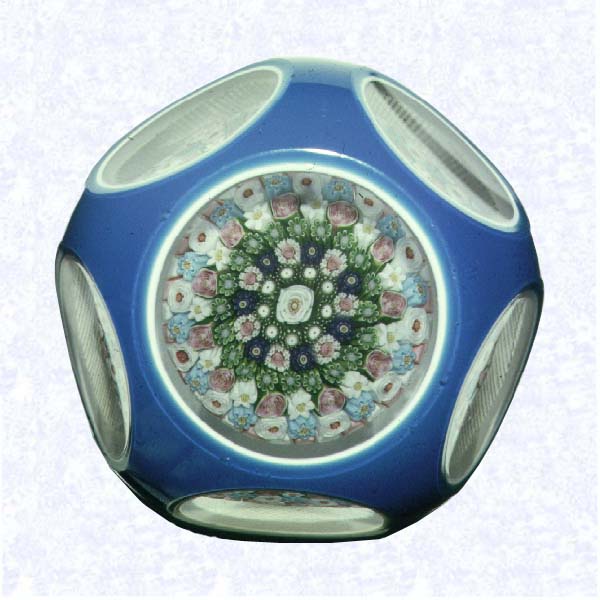 <B>Turquoise Overlay<BR>France<BR>Clichy, circa 1845-55</B><BR>Diameter: 7.3 cm (2 7/8 inches)<BR>(702467)<BR><BR>Double overlay (opaque white overlaid with deep turquoise), enclosing a close concentric millefiori mushroom with a pink and white stave basket, including one white and eleven pink Clichy roses; grid-cut base; sides cut with five circular printies, one on top