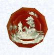 Sulphide Hunter and DogFranceBaccarat, circa 1845-55Diameter: 8.2 cm (3 1/4 inches)(702254)Sulphide scene of a hunter and dog; set on a translucent red footed base; sides cut with triangular facets; ten-sided facet cut on top