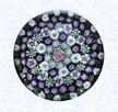 Close Concentric Millefiori with Nineteen Clichy RosesFranceClichy, circa 1845-55Diameter: 8 cm (3 1/8 inches)(702278)Close concentric millefiori with six concentric rings of millefiori canes in deep purple, pink, green, and white around a pink Clichy center rose; eighteen white Clichy roses alternate with green canes in the second outermost ring; pink and white stave basket