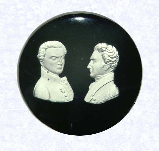<B>Presidential Doorknob<BR>United States<BR>New England Glass Company (attributed)<BR>Cambridge, Massachusetts, circa 1852-1880</B><BR>Diameter: 6.7 cm (2 5/8 inches)<BR>(702282)<BR><BR>Tribute doorknob; double sulphide portrait of Presidents James Monroe (left) and William Henry Harrison (right); &quotMONROE" and &quotHARRISON" inscribed along base of respective portraits; set on an opaque black ground; brass fitting<BR><BR>These two presidents sided with the protectionists in Congress who raised foreign tariffs on imported glass in 1816. The New England Glass Company honored the two politicians who sponsored the legislation, Henry Clay and Daniel Webster, and the two presidents by featuring their portraits in sulphides.