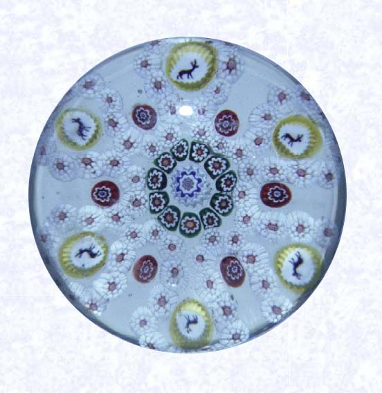 <B>Six-lobed Garland Millefiori<BR>France,<BR>Baccarat, circa 1845-55</B><BR>Diameter: 7 cm (2 3/4 inches)<BR>(702301)<BR><BR>Garland millefiori with a white six-lobed garland, encircling a ring of green, red, and white canes around a white and blue center cane; yellow silhouette canes spaced in each lob, single red canes spaced between lobes