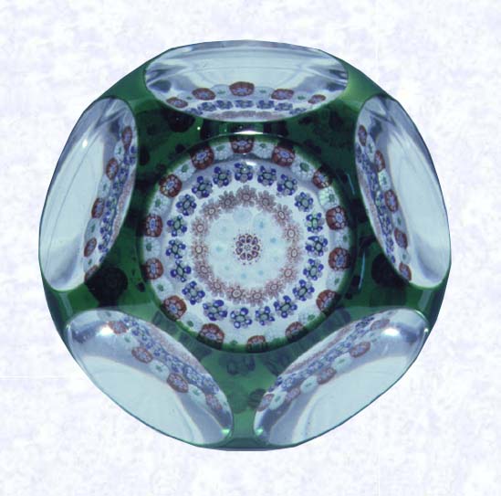 <B>Emerald Green Overlay<BR>France<BR>Baccarat, circa 1945-55</B><BR>Diameter: 6.7 cm (2 5/8 inches)<BR>(702314)<BR><BR>Single overlay of translucent emerald green, enclosing a spaced concentric millefiori design; sides cut with five circular printies, one on top