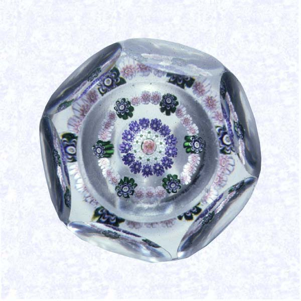 <B>Pattern Millefiori with Clichy Rose<BR>France<BR>Clichy, circa 1845-55</B><BR>Diameter; 6.5 cm (2 1/2 inches)<BR>(702343)<BR><BR>Pattern millefiori with concentric rings of millefiori canes in white, pink, green, and purple, around a central pink Clichy rose; sides cut with six circular printies, one on top