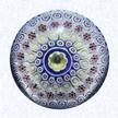 Bacchus Close Concentric MillefioriEnglandGeorge Bacchus and SonsUnion Glass Works, Birmingham, circa 1845-55Diameter: 8.6 cm (3 3/8 inches)(&02345)Close concentric millefiori with five concentric rings of millefiori canes in white, blue, orange, and yellow encircling a large yellow-lined pastry-mold center cane