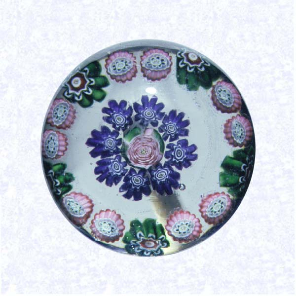 <B>Miniature Pattern Millefiori with Clichy Rose<BR>France<BR>Clichy, circa 1845-55</B><BR>Diameter: 4.5 cm (1 3/4 inches)<BR>(702357)<BR><BR>Miniature pattern millefiori weight with concentric rings of millefiori canes in green, pink, and purple, around a central pink Clichy rose
