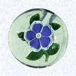 Miniature Lampworked Blue PrimroseFranceBaccarat, circa 1845-55Diameter: 4.5 cm (1 3/4 inches)(702390)Miniature weight with a deep blue and white lampworked primrose blossom with a white center cane; five green leaves and stem; star-cut base