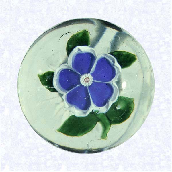 <B>Miniature Lampworked Blue Primrose<BR>France<BR>Baccarat, circa 1845-55</B><BR>Diameter: 4.5 cm (1 3/4 inches)<BR>(702390)<BR><BR>Miniature weight with a deep blue and white lampworked primrose blossom with a white center cane; five green leaves and stem; star-cut base