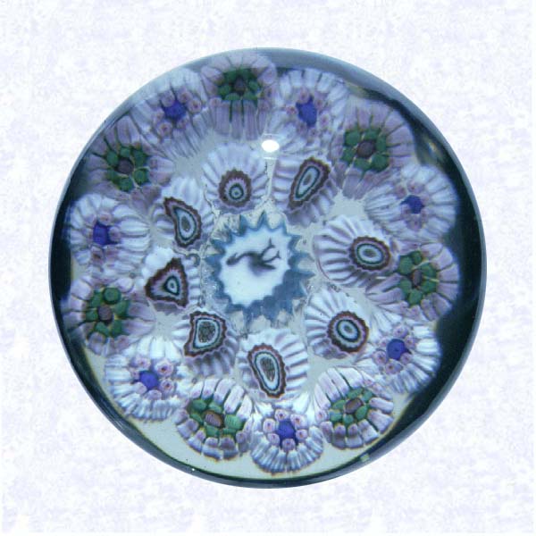 <B>Miniature Millefiori with Silhouette Cane<BR>France<BR>Baccarat, circa 1850-1950</B><BR>Diameter: 4.5 cm (1 3/4 inches)<BR>(702410)<BR><BR>Miniature close concentric millefiori weight with a circa 1850 antique pelican silhouette cane, encircled by two concentric rings on later Baccarat canes in white and pale pink