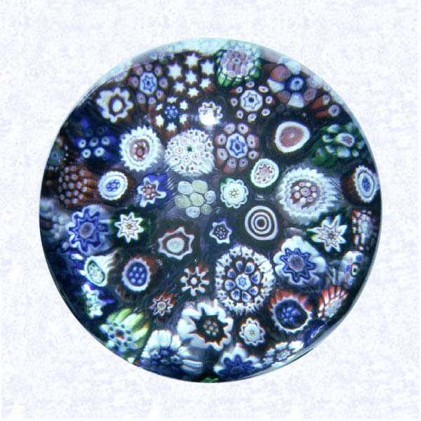 <B>Miniature Close Millefiori<BR>France<BR>Baccarat, circa 1845-55</B><BR>Diameter: 4.5 cm (1 3/4 inches)<BR>(702421)<BR><BR>Miniature close millefiori weight composed of various star, cog, bull's eye, and spiralling canes