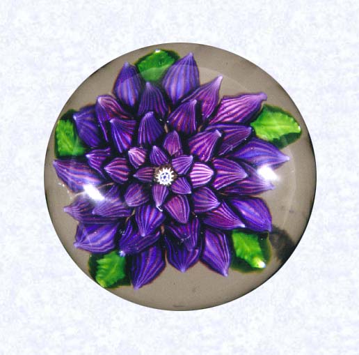 <B>Lampworked Purple Dahlia<BR>France<BR>Saint Louis, circa 1845-55</B><BR>Diameter: 7.3 cm (2 7/8 inches)<BR>(702452)<BR><BR>Large purple lampworked dahlia blossom with five overlapping layers of striped petals (red, white, and blue); white, blue, and yellow center cane; five green leaves; star-cut base
