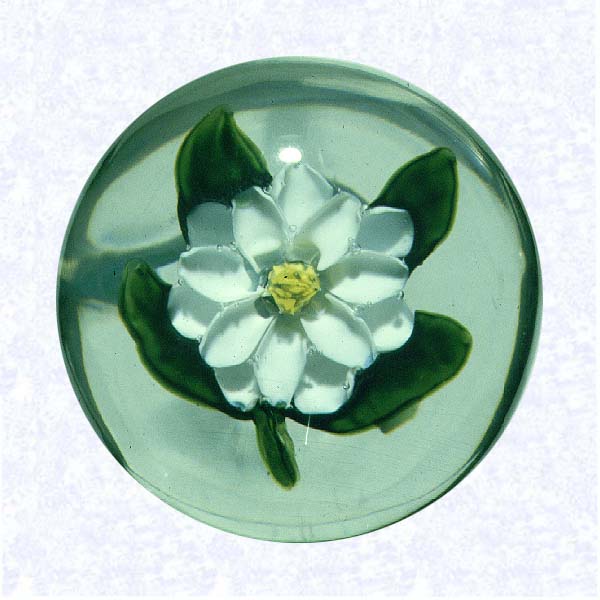 <B>Miniature Lampworked White Blossom<BR>France<BR>Pantin (attributed), circa 1845-55</B><BR>Diameter: 4.5 cm (1 3/4 inches)<BR>(702472)<BR><BR>Miniature weight with a lampworked white flower blossom resembling a magnolia; deeply cupped petals with a yellow center cane; four green leaves and small stem