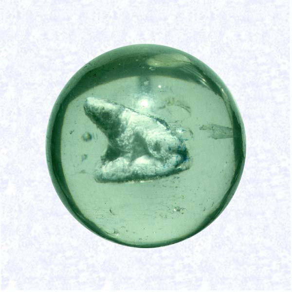 <B>Sulphide Marble<BR>Europe or United States<BR>factory unknown, circa 1920</B><BR>Diameter: 3.5 cm (1 3/8 inches)<BR>(702489)<BR><BR>Clear glass marble enclosing a sulphide figure of a seated dog