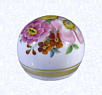 Hand-painted Paperweight (view two)Bohemiafactory unknown, circa 1850-1900Diameter: 6.5 cm (2 1/2 inches)(702341)Clear glass weight overlaid with opaque white glass; hand-painted flowers in pink, yellow, blue, and rust with green leaves; two gilded bands encircling base; deep star-cut extending to perimeter of base